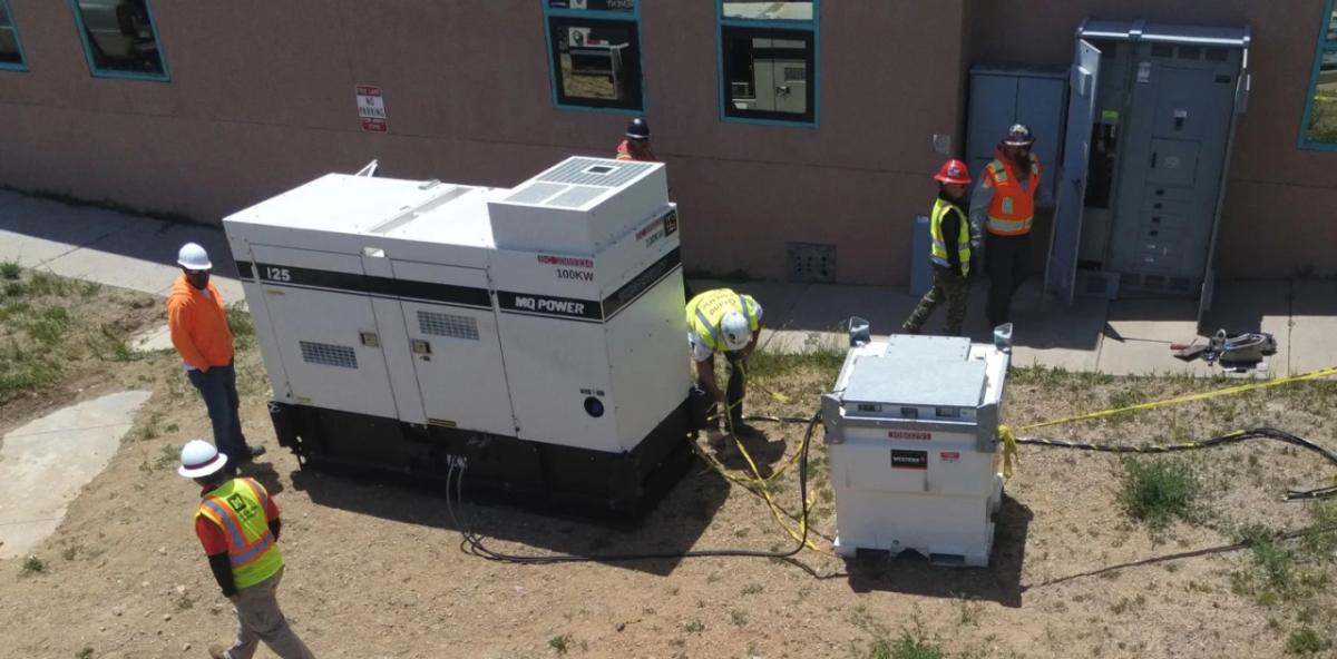 an outdoor generator being installed by a small team
