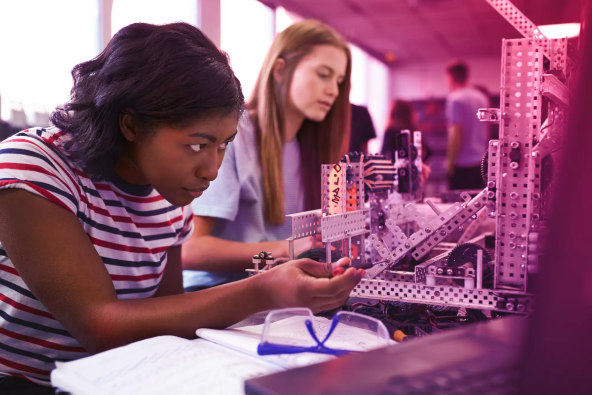 Students working on a machine