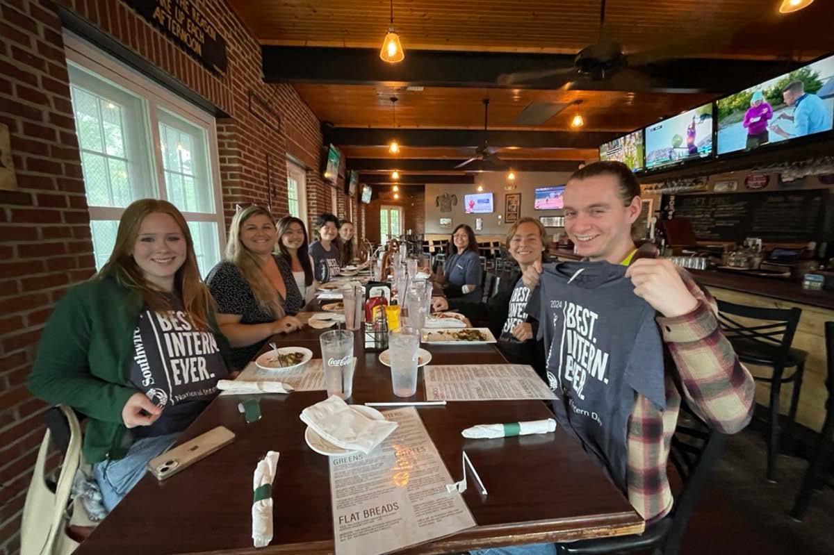 Southwire interns holding up "Best Intern Ever" t-shirts