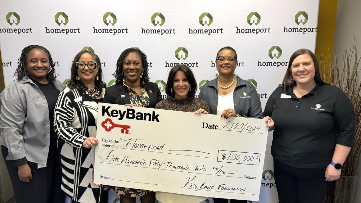 People standing together with check from KeyBank