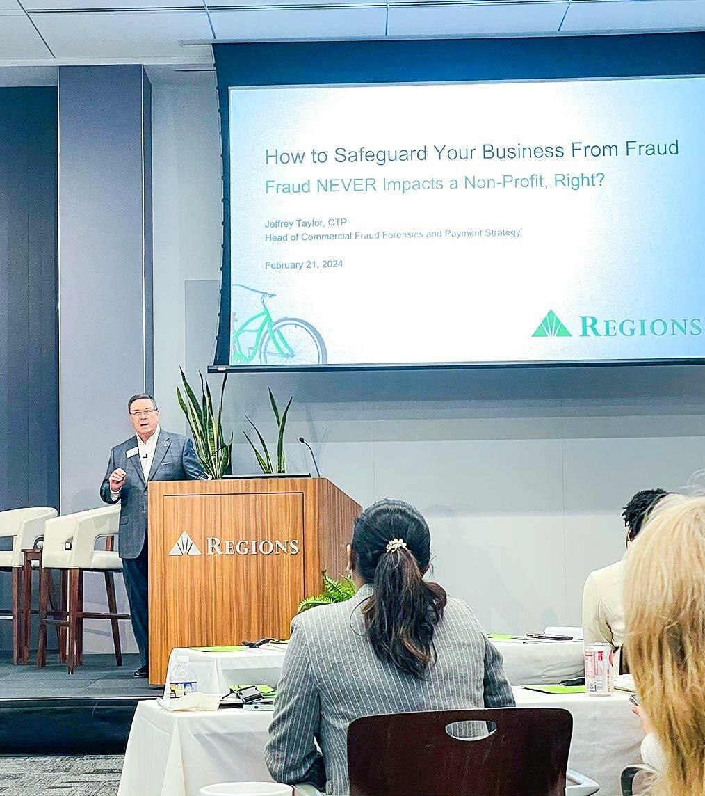 A person stood on stage speaking at an event