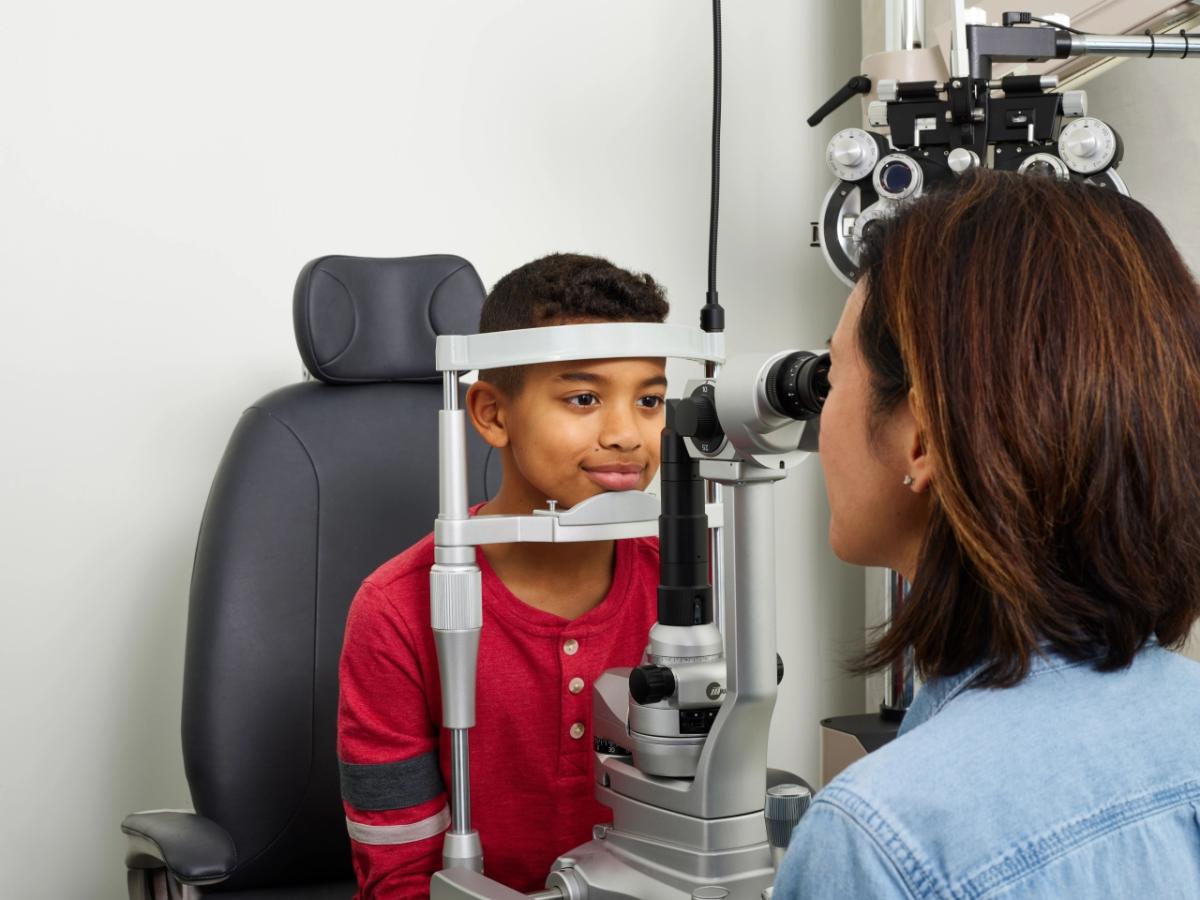Eye doctor examining young boy 