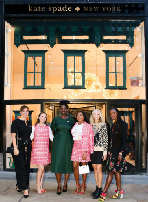A group of six women outside a kate spade store