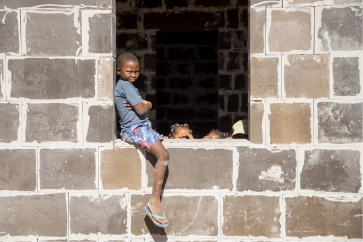 Kid sitting on window