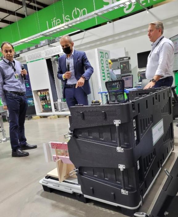 Three people inspecting a machine.