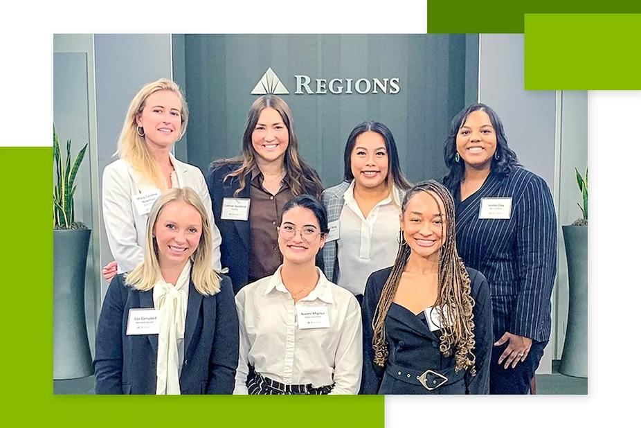 Six people posed, a Regions sign behind them.