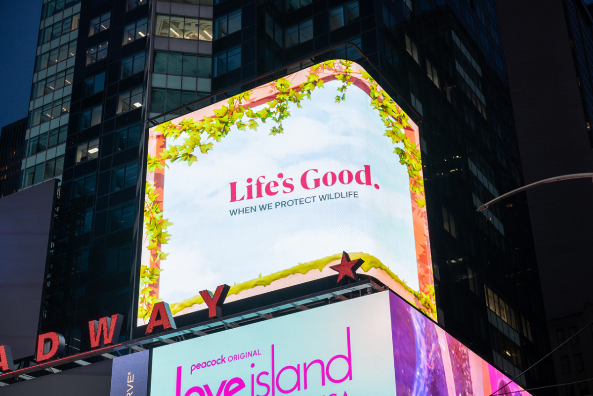 Lit billboard: "Life's Good when we protect wildlife"