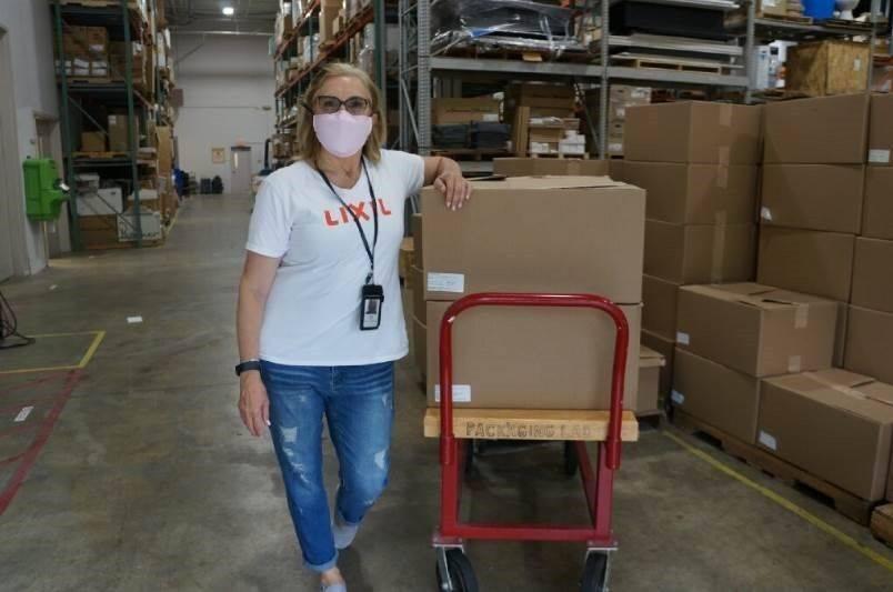 LIXIL employee Debbie Drury distributes face shields at the company’s headquarters in Piscataway, N.J. to LIXIL employees across the country to distribute in their respective communities. Piscataway-based LIXIL, home to the kitchen and bath brand American Standard, recently expanded their efforts to make face shields for front line workers and teamed up with a local volunteer group called Jersey City Rapid Maker Response Group (JCRMRG) to manufacture and distribute thousands of face shields to first responders and medical workers in communities across the US battling COVID-19. LIXIL is donating 50,000 shields to communities it serves both in its backyard in NJ and across the U.S.