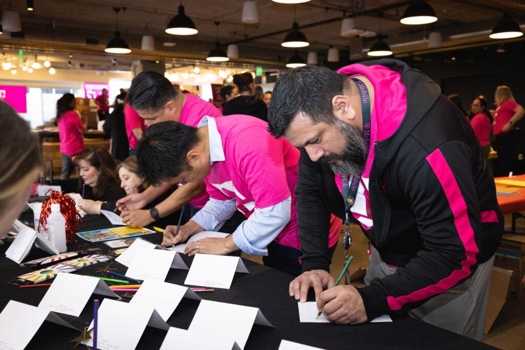 Volunteers writing on cards.