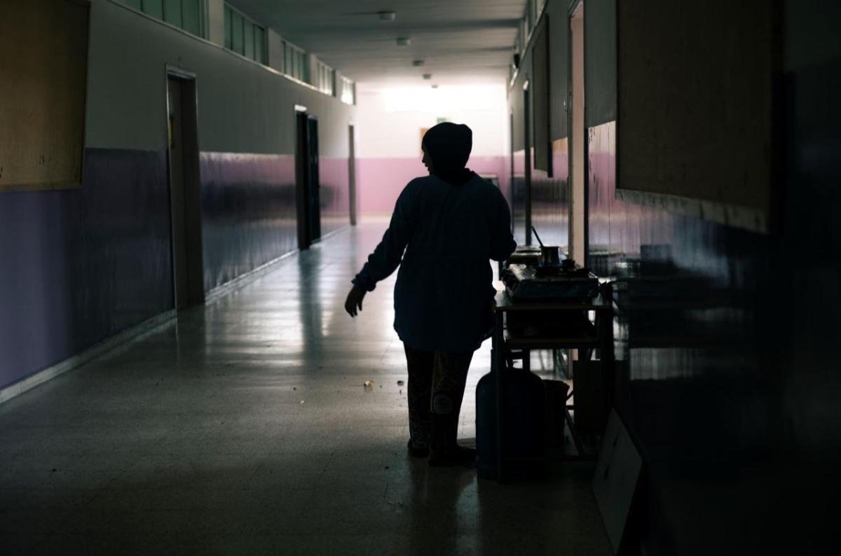 A woman cooks in one of the corridors of the Supplementary School for Girls in Tyre, Lebanon, where hundreds of people displaced by the armed conflict in southern Lebanon are sheltering. A woman cooks in one of the corridors of the Supplementary School for Girls in Tyre, Lebanon, where hundreds of people displaced by the armed conflict in southern Lebanon are sheltering.