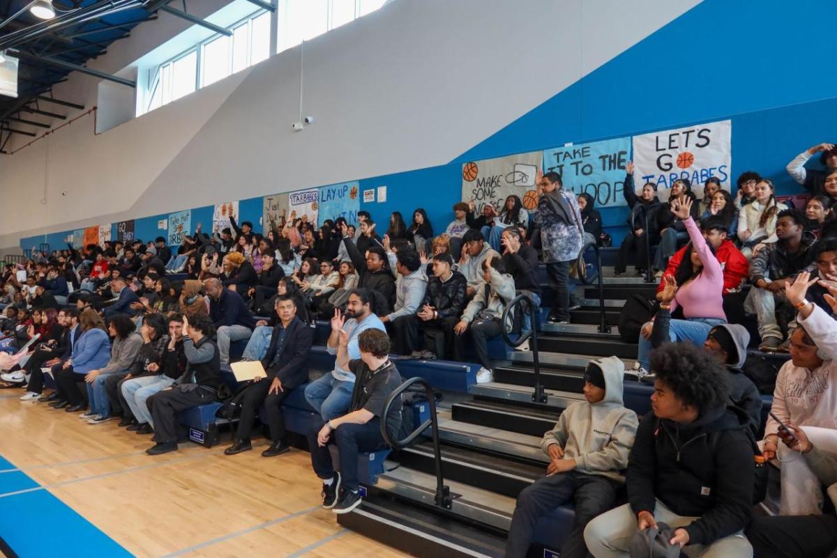 Students fill the gymnasium at Compton High School, actively engaging in the career panel through questions and conversation with AEG professionals.