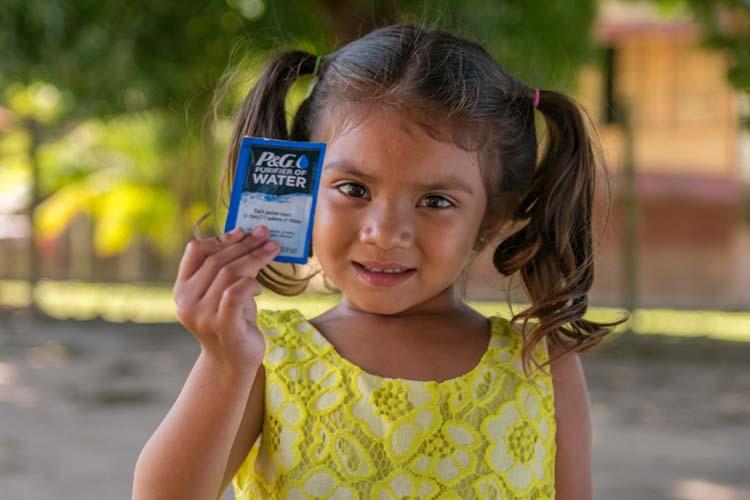 girl holding P&G water packet