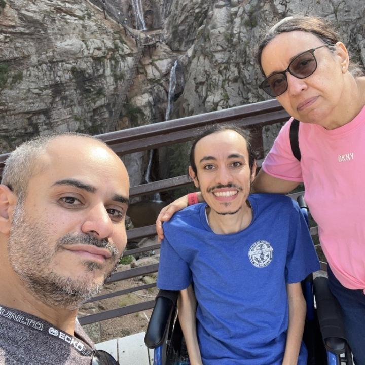 Peter Mansour with family in front of a scenic spot.