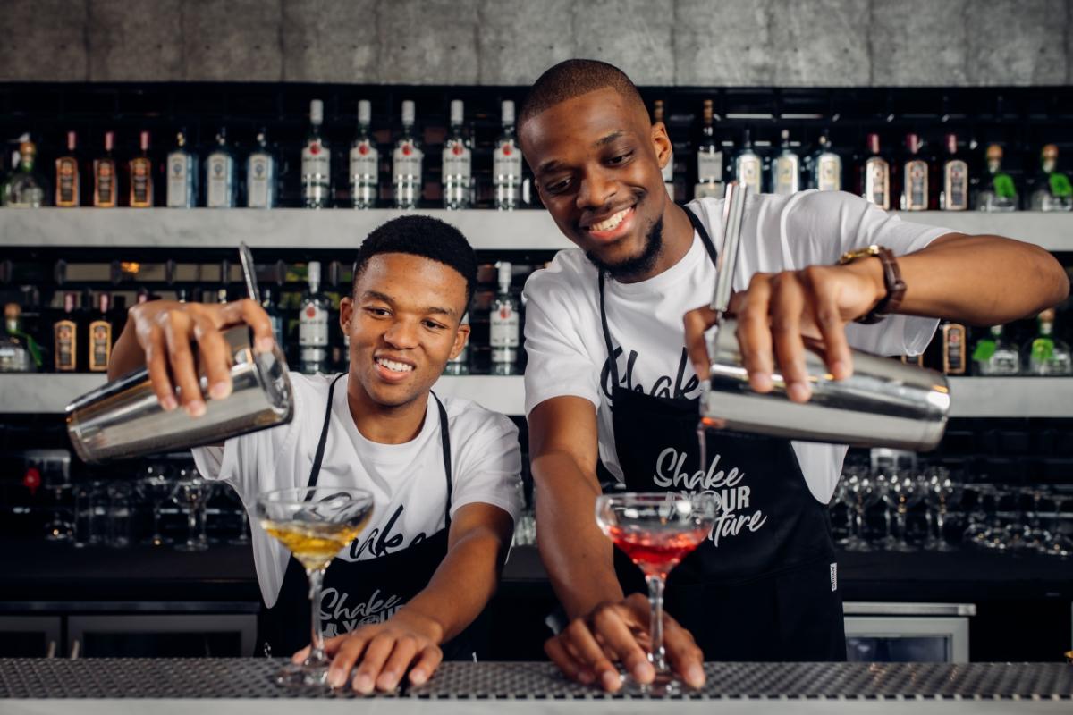 two men pouring drinks