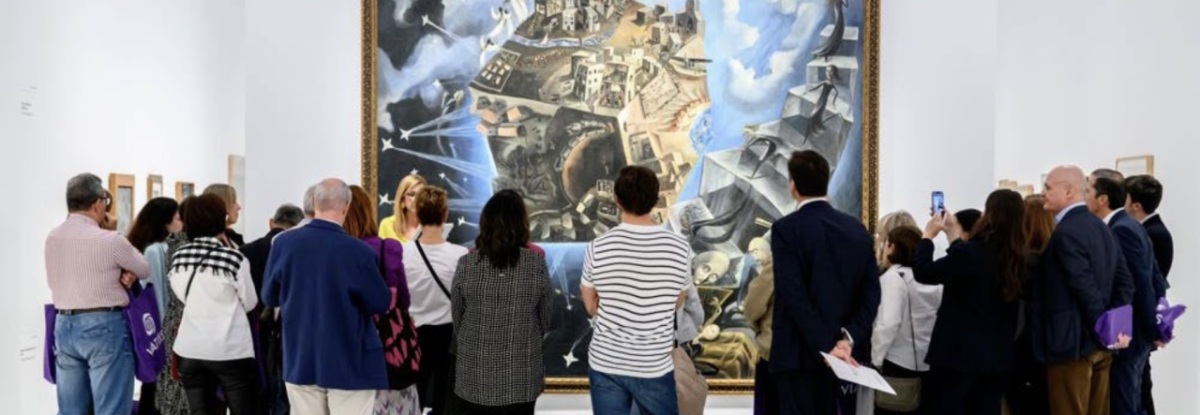 Group viewing large painting