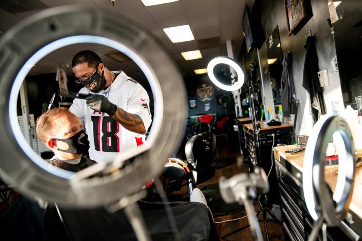 Marcus Johnson, owner of ManCave Barber Shop in Layton, cuts Doug Nielsen’s hair on Tuesday, Dec. 1, 2020. Spenser Heaps, Deseret News
