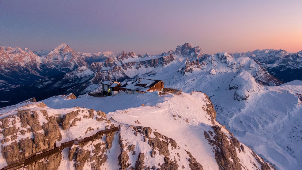 Building on a high mountain top at sunset