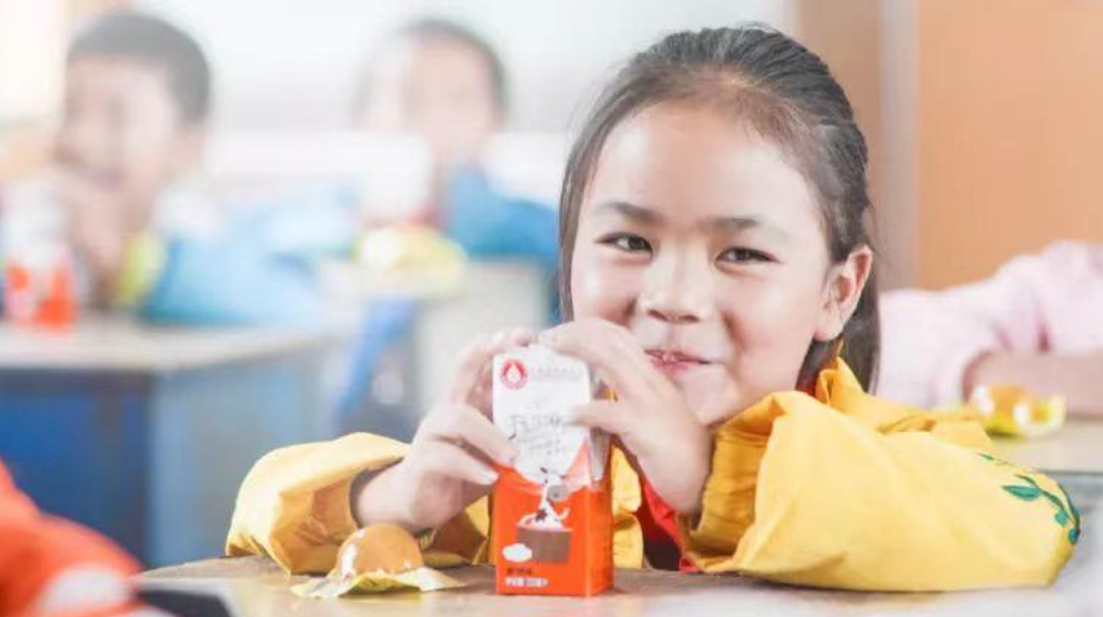 Girl drinking milk and smiling
