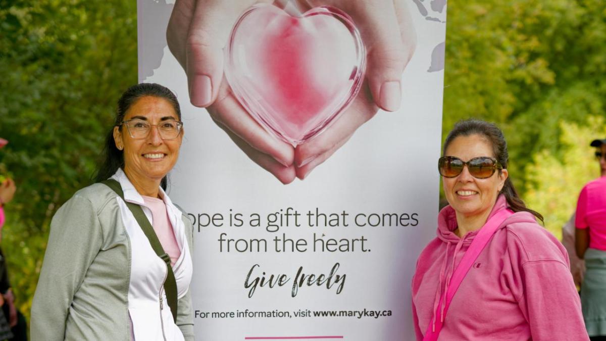 Taking place both in person and virtually, this year’s MK5K was a resounding success, reflecting the Foundation’s mission to support people living with cancer through Look Good Feel Better® and to help women experiencing domestic violence by providing grants to women's shelters and community outreach programs. (Photo Courtesy: Gord Simpson) two people standing in front of a banner about the event