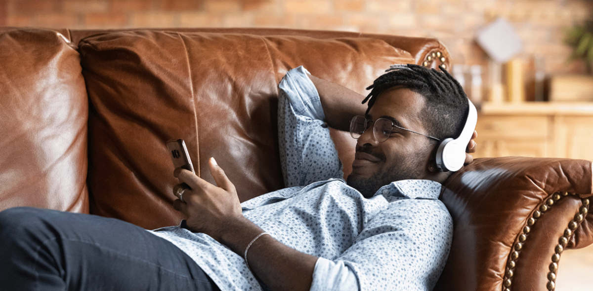 Mobile phone user unwinding on the sofa