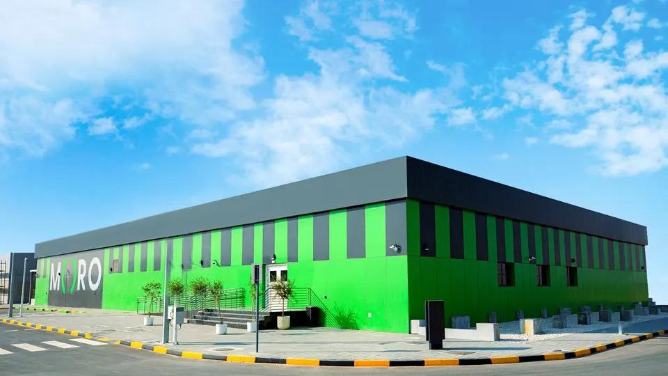 A building exterior painted black and green. "MORO" on the side.