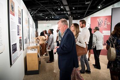 People viewing museum exhibits.