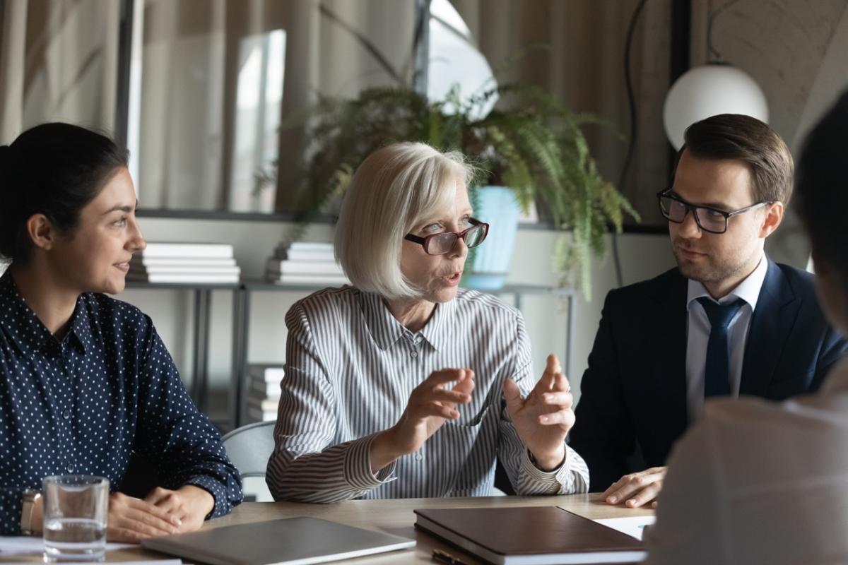 business people speaking around a table