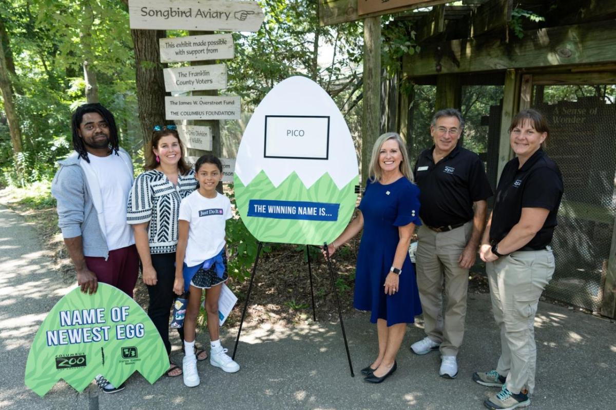 Fifth Third Bank and the Columbus Zoo and Aquarium partnered to give an opportunity for a community member to name the first hatching of 2023 and start their own nest egg. In the photo, to the left of the egg, is the winner Elizabeth Salazar with her husband and daughter. To the right, is Elizabeth Boyuk, Fifth Third’s vice president of regional marketing, Dr. Michael Kreger, Columbus Zoo’s vice president of conservation, and Nikki Smith, Columbus Zoo’s curator of North America region. " "