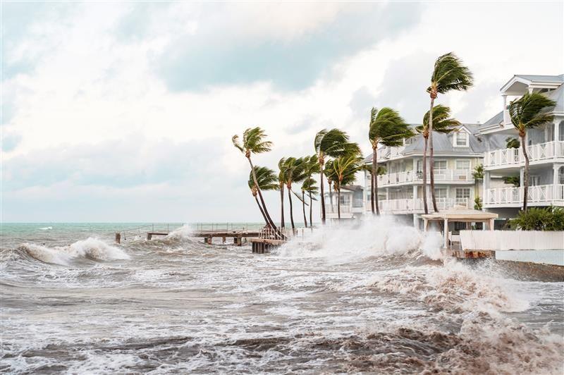 Stormy seas next to apartment buildings