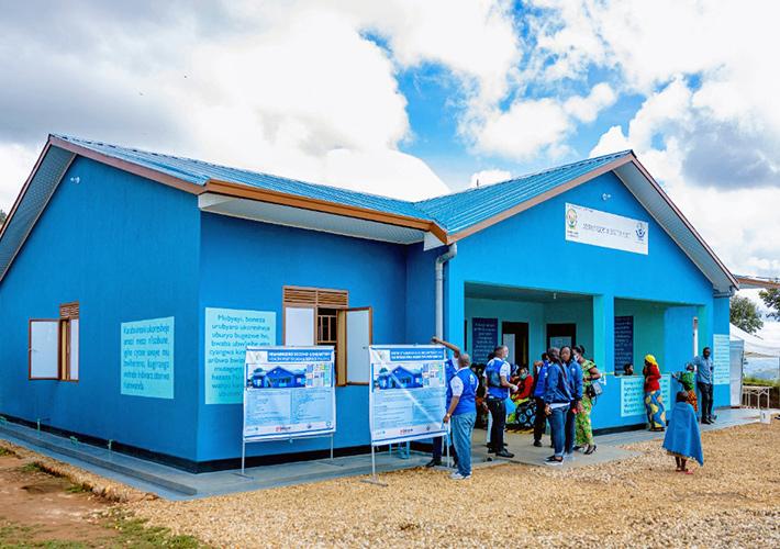 a bright blue building, people coming in and out