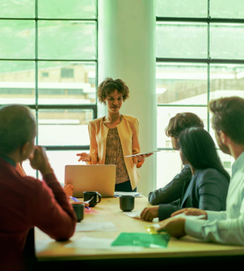 Woman talking to people in board room