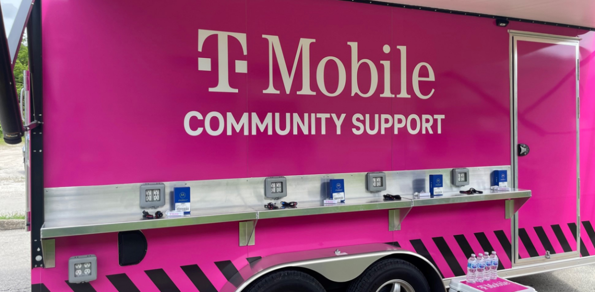 TMobile logo on the side of a pink vehicle "community support" equipped with charging ports