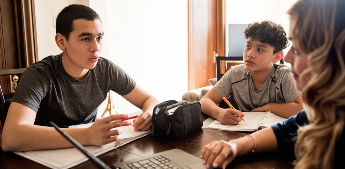 Students sitting around a laptop