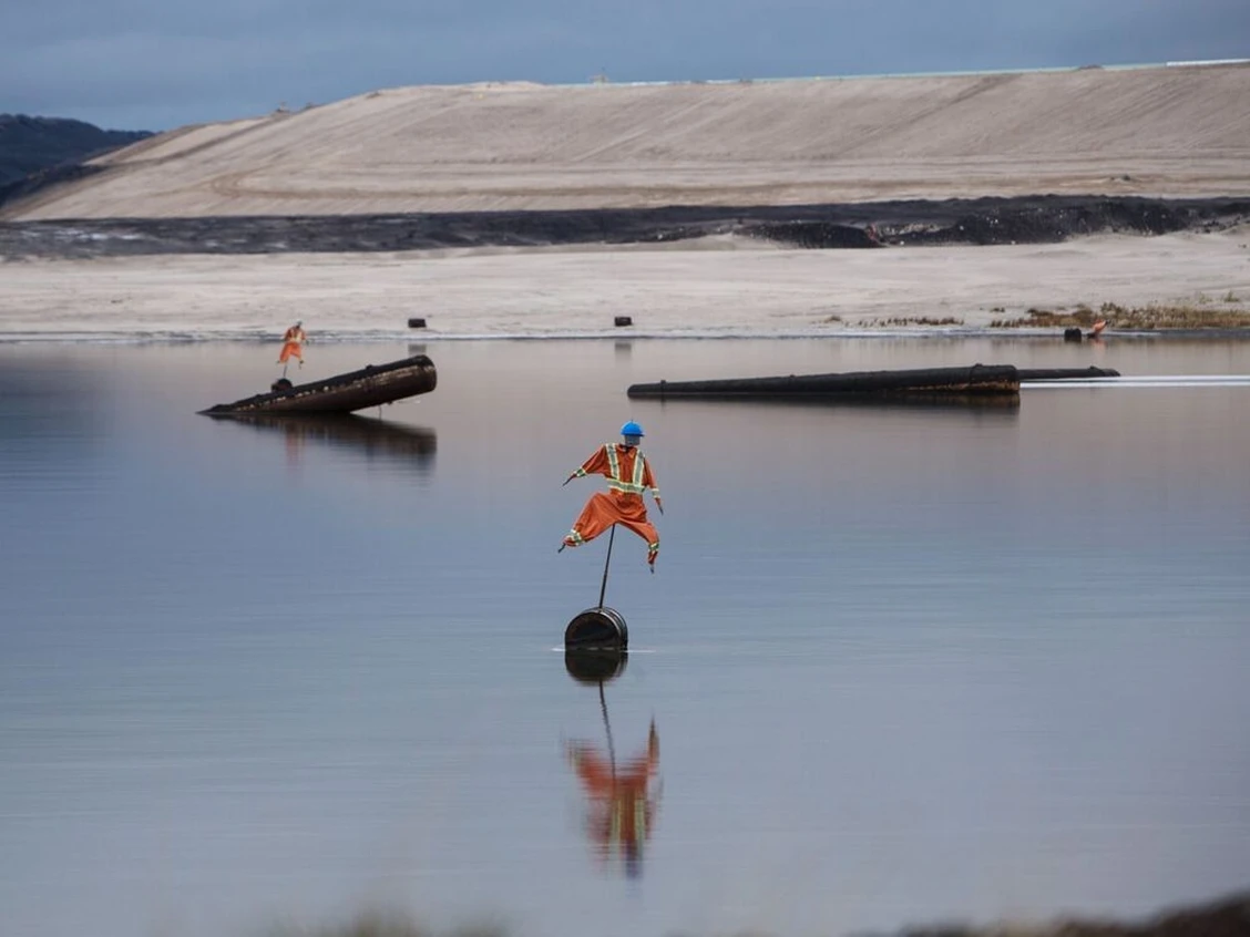 Scarecrows, used to deter birds from landing, stand in the Syncrude Canada Ltd. tailings pond in the Athabasca Oil Sands near Fort McMurray, Alberta, Canada, on Sunday, September 9, 2018. PHOTO BY BEN NELMS/BLOOMBERG /Postmedia Archive. Image courtesy of Calgary Herald.