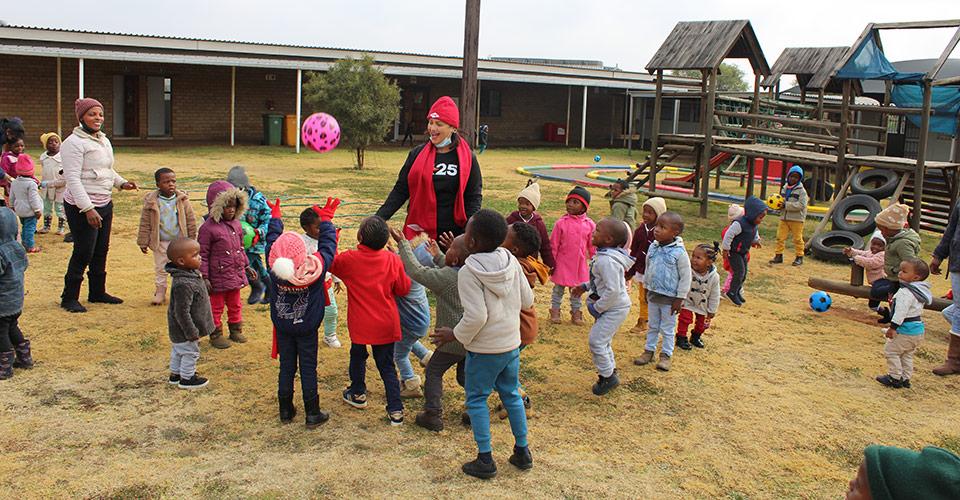 a group of children playing outside in a courtyard