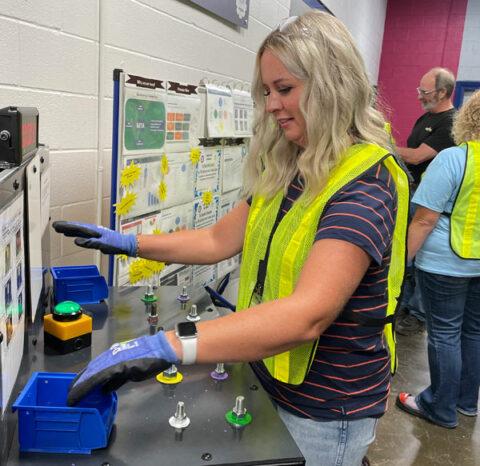 Teacher wearing gloves and yellow vest 