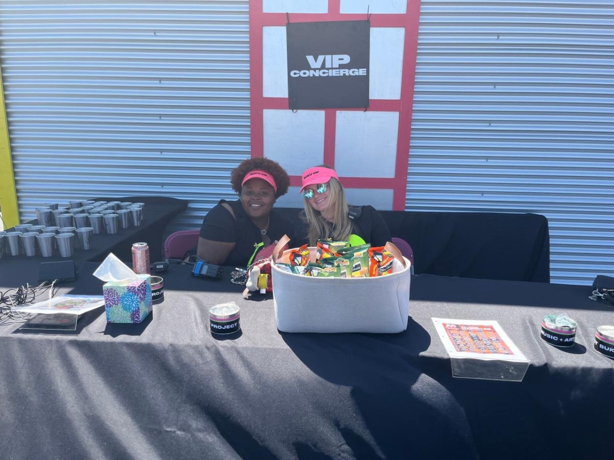 Two people working at the VIP Concierge table