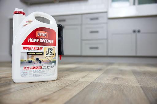 example of new packaging showing container of Home Defense on the floor of a kitchen