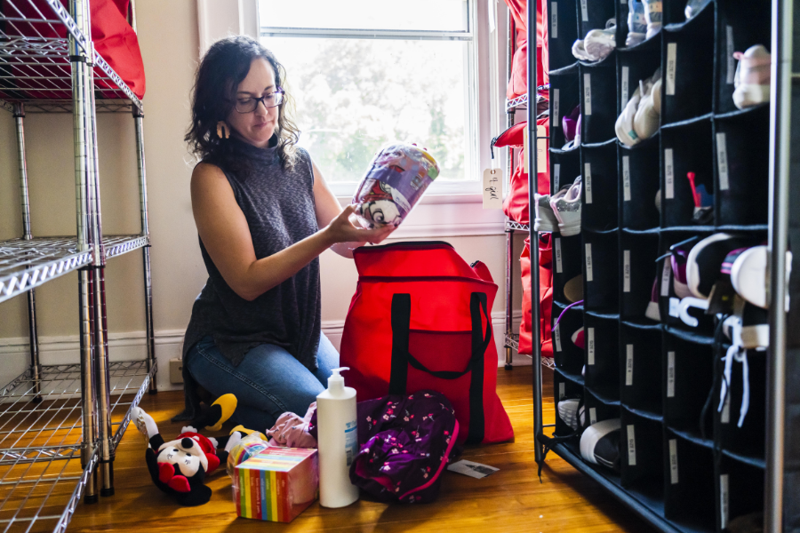 Becky packing a red bag with supplies.