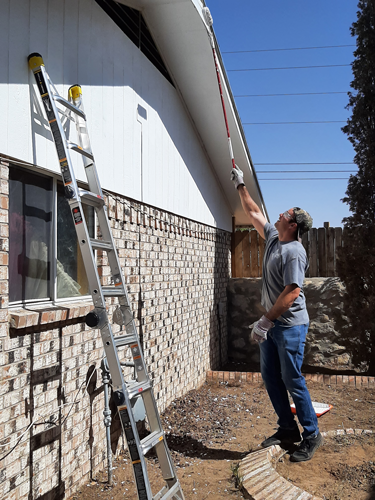 Volunteer painting a house