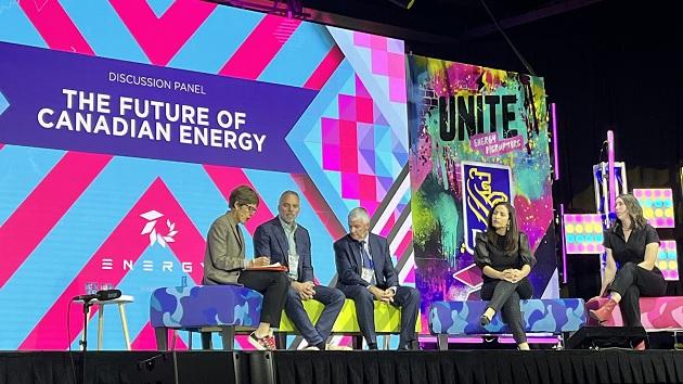 From left, moderator Deborah Yedlin (President and CEO, Calgary Chamber of Commerce) and panelists Colin Gruending (Enbridge), Mike Rose (Tourmaline), Nagwan Al-Guneid (Business Renewables Centre Canada) and Olivia Reshetylo (Modern West Advisory) during a Sept. 20 mainstage discussion at the Energy Disruptors Summit entitled The Future of Canadian Energy. Panel and moderator seated on a stage, "The Future of Canadian Energy" on a large screen behind them.