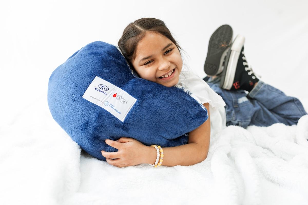 child holding a pillow