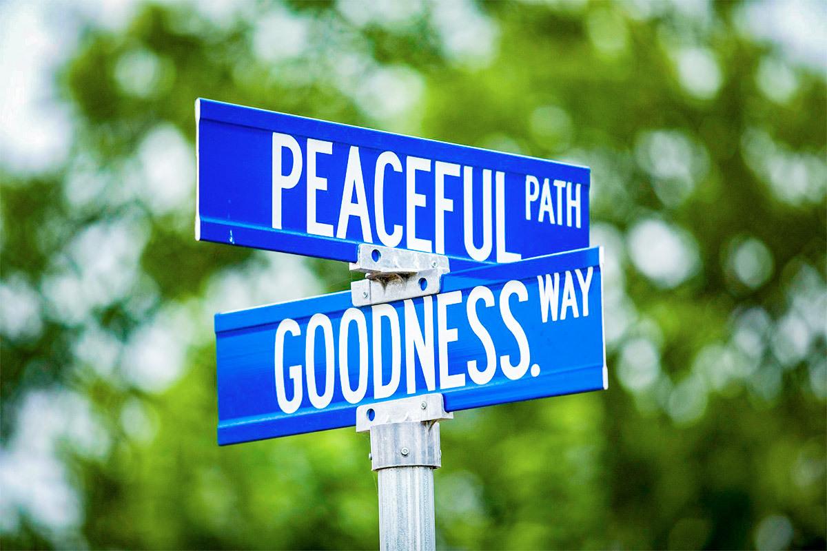 Sign post with "Peaceful path and Goodness way"