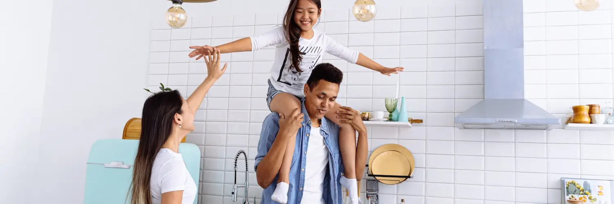 Child playing on parents shoulders