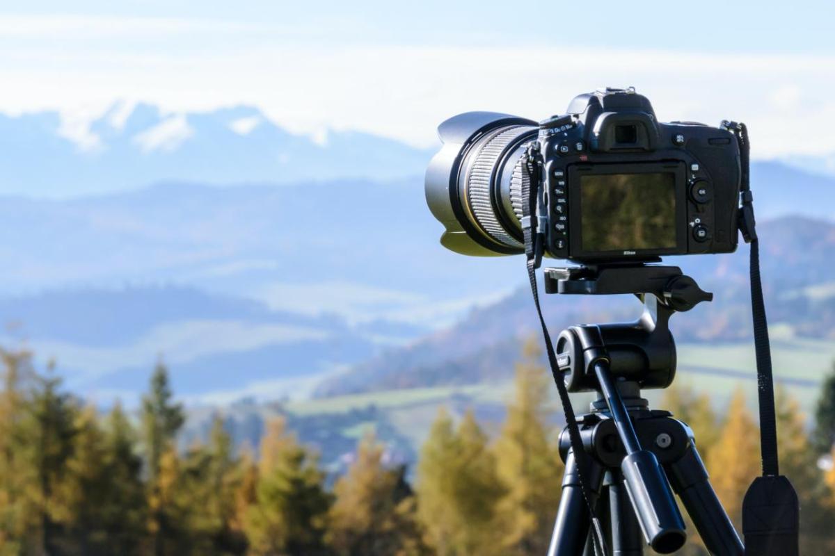 Camera on a tripod looking out over a mountain landscape