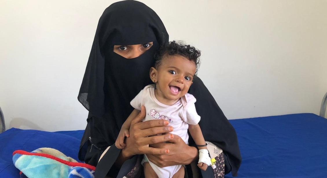 In Yemen, Maimuna, 21, sits with her 8-month-old daughter, who is receiving treatment for severe acute malnutrition.