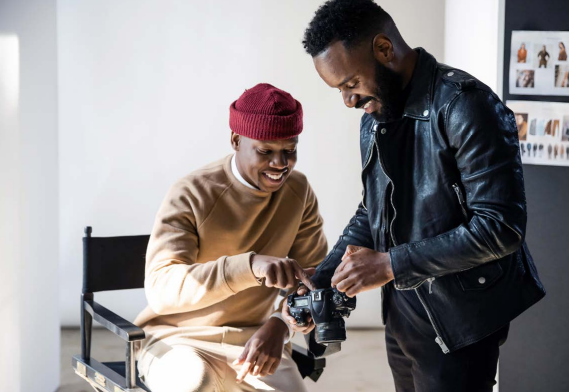 Two people looking at a camera