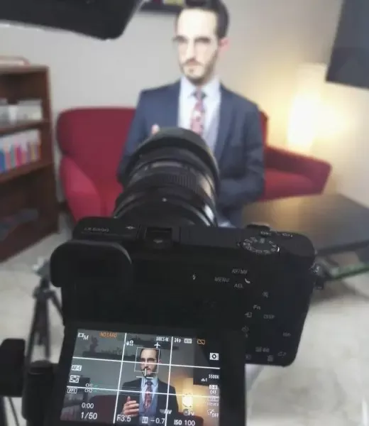 Ruggero Rollini in an interview, focused image on a camera screen.