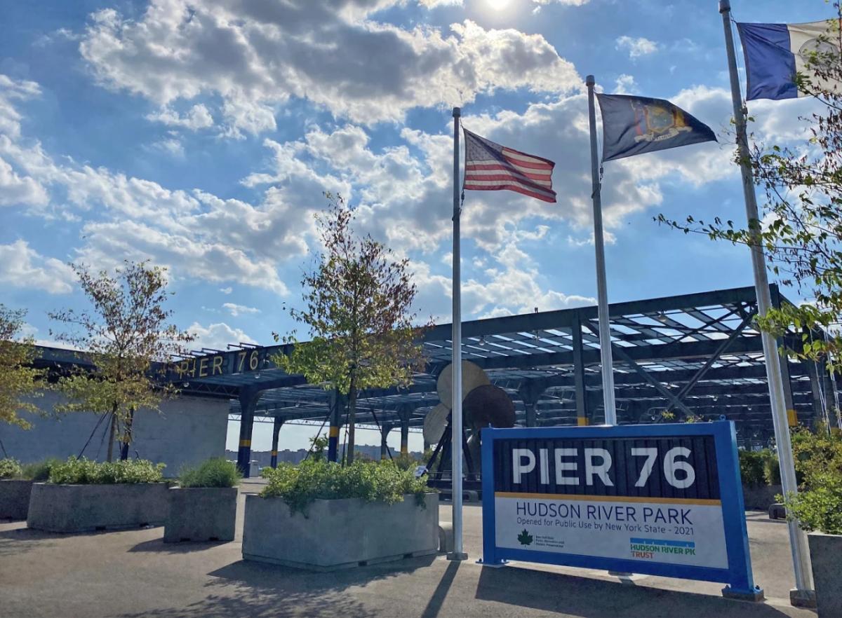 sign for Pier 76 and three flags