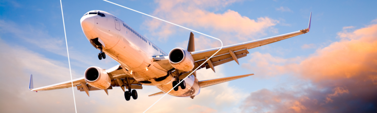 a plane in the air, clouds in a blue sky behind it